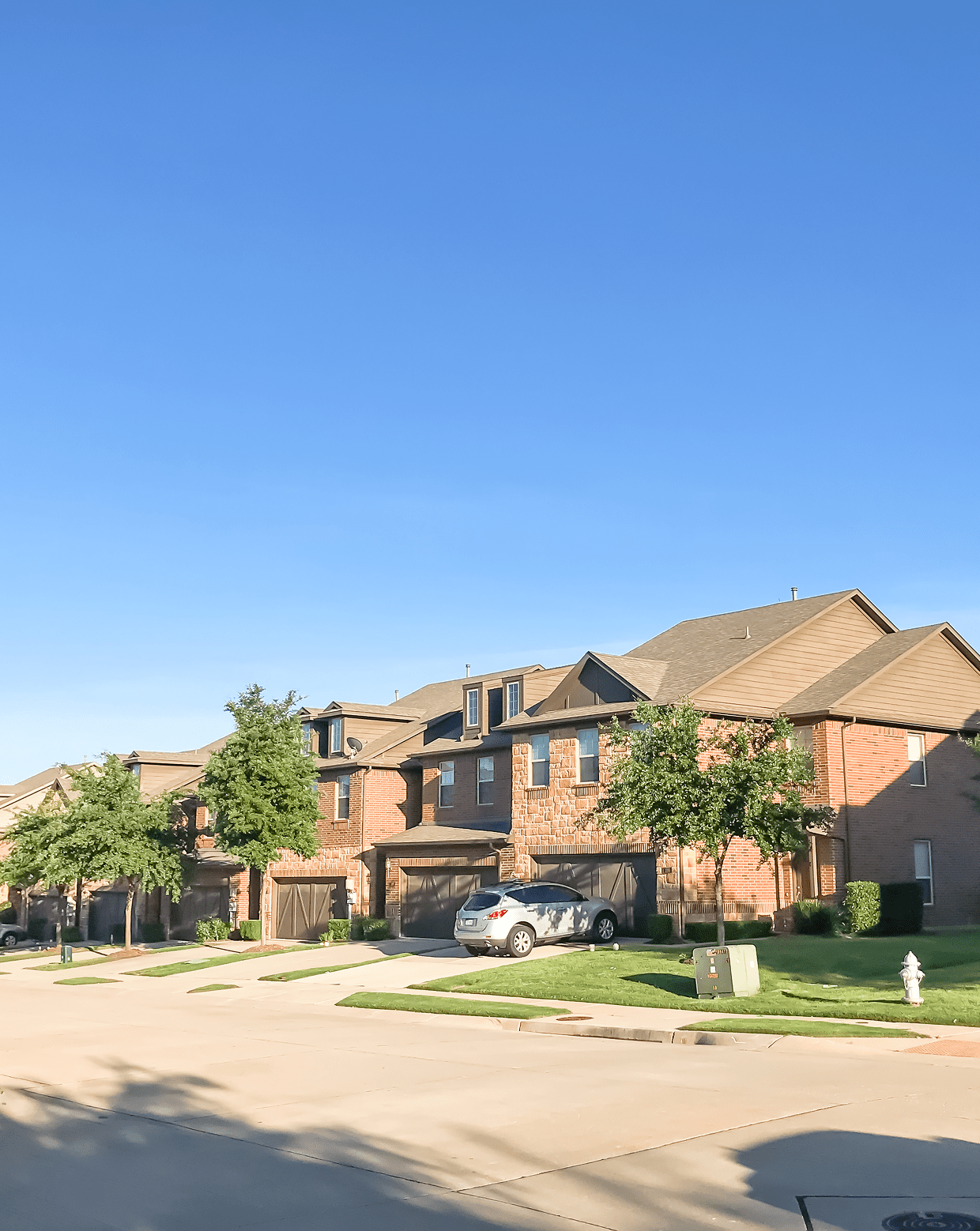 Residential neighborhood under clear blue sky