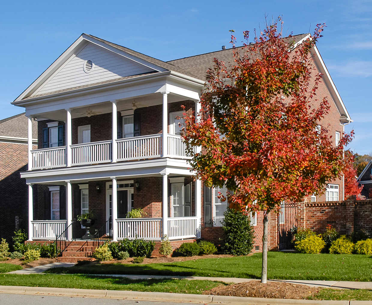 Elegant house with red foliage tree
