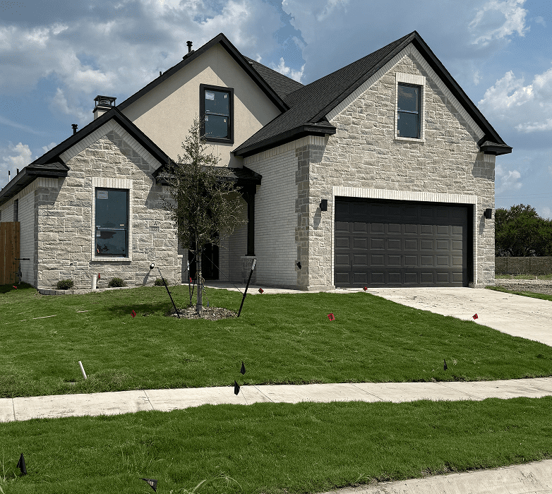 New suburban home with green lawn